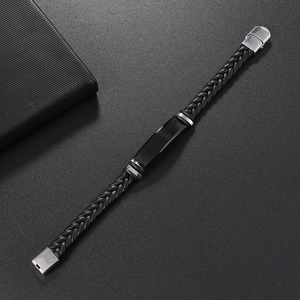 Macro shot of men's black braided leather bracelet with polished silver metal buckle