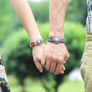 Handmade woven leather couple bracelets with vintage buckles in scenic outdoor setting