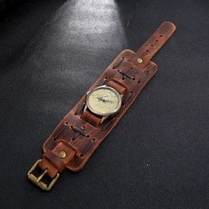 Macro detail of retro wide leather watch strap with woven textures and bronze studs