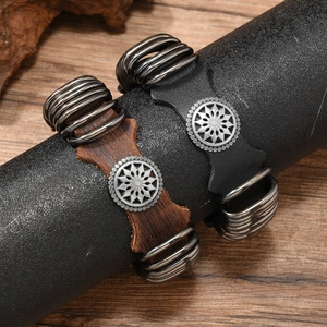 Detailed macro view of vintage punk leather bracelets with embossed floral metal buckles