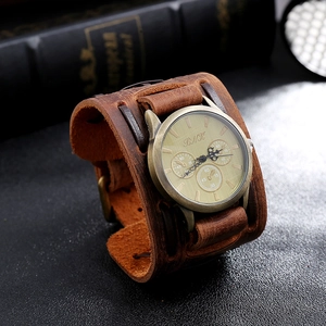 Detail of vintage brown wide leather strap and industrial gold dial with steampunk style
