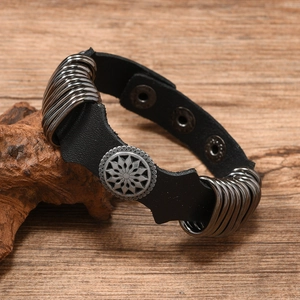 Detail of punk leather bracelet showing vintage silver alloy disks and snap fasteners