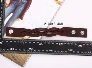 Detailed view of a vintage braided leather bracelet with scale showing 21cm x 2.4cm size