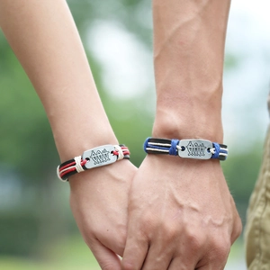 Handmade woven leather couple bracelets with vintage metal plates and abstract fish engraving