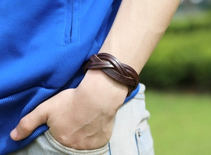 Close-up of a men's vintage brown woven leather bracelet on a model's wrist