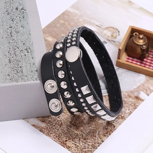 Detail of black leather punk bracelet with silver studs and metal snap buttons