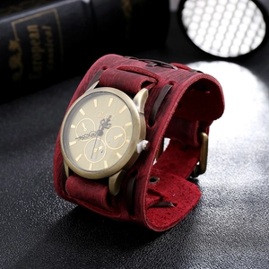 Detail of vintage red leather strap with stitching and bronze punk quartz watch dial