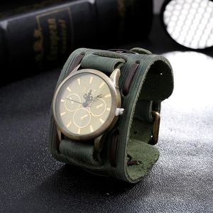 Detail of army green suede leather strap with bronze rivets on punk vintage watch