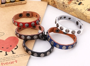 Detailed set of five punk leather bracelets with metal star studs in assorted colors