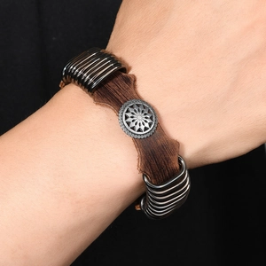 Adjustable punk style brown leather bracelet with sun emblem and metal ring studs