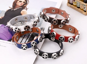 Detail of leather punk bracelets with silver cross studs and adjustable metal snaps