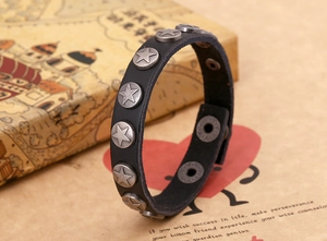 Detail of punk leather bracelet with vintage silver star studs and snap closure