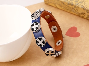 Detail view of blue leather punk bracelet with silver hollow cross metal buttons
