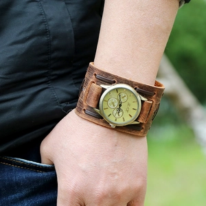 Detail of vintage brown leather strap and bronze dial on a punk style men's watch