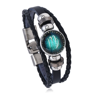 Close-up of Virgo zodiac leather bracelet with glass cabochon and metal clasp