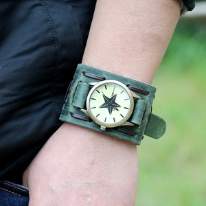 Detail of vintage green leather wide band watch with a black star dial pattern