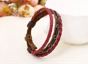 Close-up of vintage multilayer braided leather bracelet with bronze metal eyelets