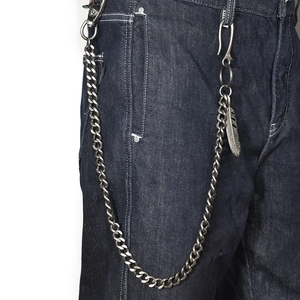 Retro hip hop punk wallet chain with vintage feather pendant on blue denim jeans