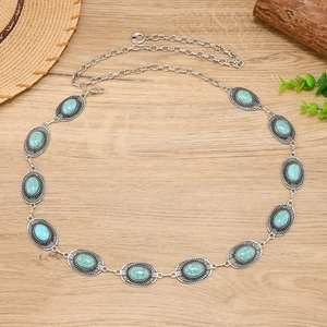 Detail of Bohemian silver chain belt featuring turquoise stones and vintage floral carving