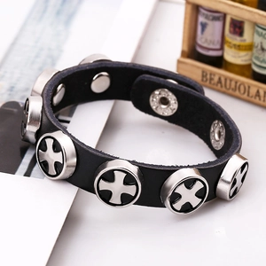 Punk black leather bracelet with metal cross rivets and snap buttons on white background