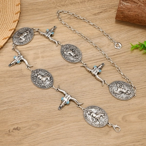 Vintage western silver belt featuring bull skull and horse charms with turquoise