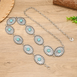 Vintage bohemian metal waist chain with turquoise sunflower engravings on wooden background