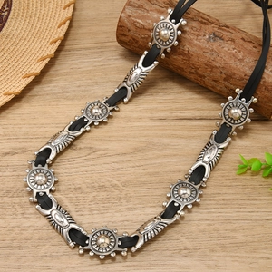 Detail of bohemian Western waist chain with vintage silver engraved metal medallions