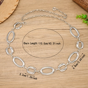 Minimalist silver metal waist chain with interlocking oval rings on a wooden surface