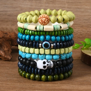 10-piece Bohemian beaded skull bracelet set with evil eye charms on a wooden display
