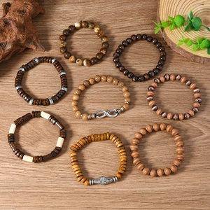 Close-up of 8-piece vintage wooden bead bracelet set with infinity charms on natural wood