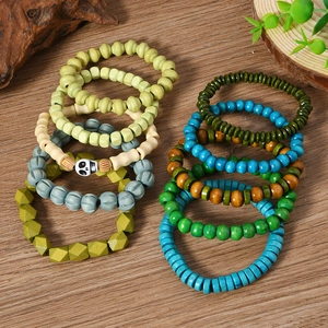 Detailed macro view of bohemian multilayer wood bead bracelet set with skull charm detail
