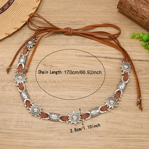 Bohemian retro PU leather belt with silver floral metal conchos on wooden background