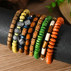 Set of 7 bohemian wooden bead bracelets in vibrant colors on a black display stand