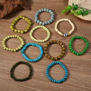 Detail of 10-piece bohemian wooden bead bracelet set with a skull accent on dark wood