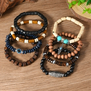 Detailed set of bohemian wood bead bracelets featuring a silver feather pendant and evil eye