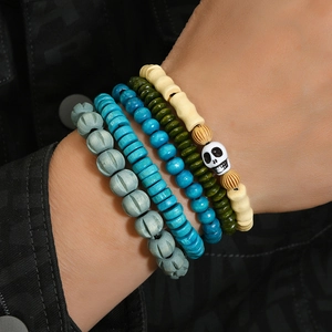 Detailed shot of multi-layer beaded bracelet set with skull charm on a wrist