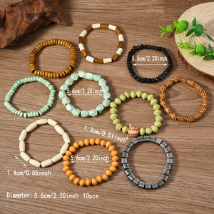 Set of 10 bohemian beaded bracelets with natural wood and stone beads on wood background