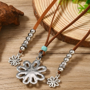 Bohemian leather necklace with turquoise beads and vintage metal flower pendants