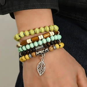 10-piece Bohemian layered beaded bracelet set with vintage leaf pendant on male wrist
