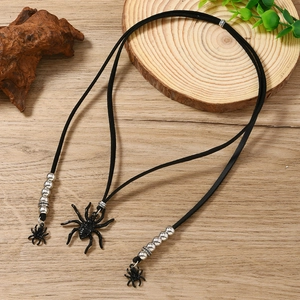 Detail of gothic black spider necklace with long tassels and silver metal beads