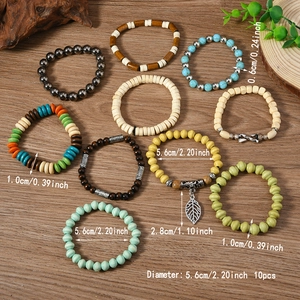 10-piece Bohemian beaded bracelet set with wood beads and leaf charms on wooden background