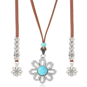 Ethnic bohemian turquoise sunflower pendant on brown leather cord necklace