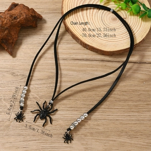 Gothic punk black spider pendant necklace with silver beads on a natural wooden background