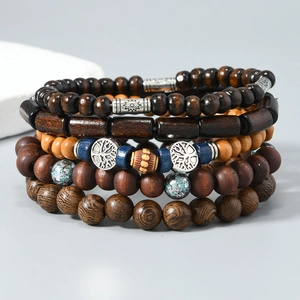 Detail of multi-layer wood bead bracelets with Tree of Life and Sun metal charms
