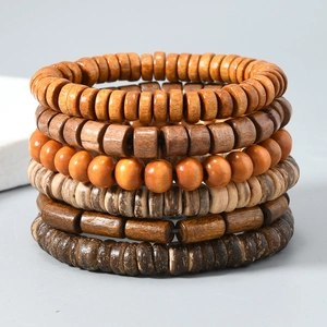 Detail of multi-layered beaded bracelets with diverse natural wood and coconut shell textures