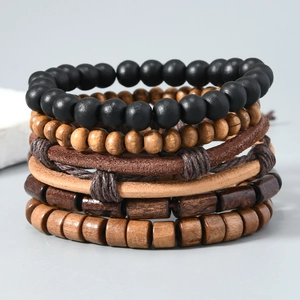 Detail showing vintage layered leather bracelets with wooden beads and coconut shells
