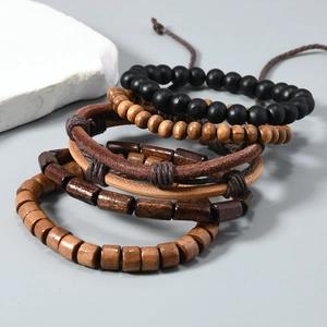Detail of 5-piece vintage set featuring wood beads and layered leather cord bracelets