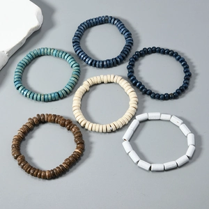 Detailed flat lay of bohemian handmade wooden bead bracelets in blue and earth tones