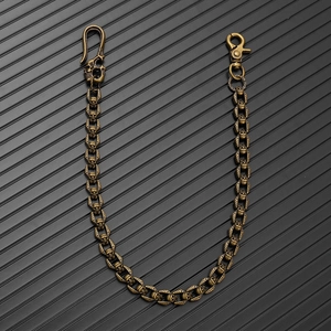 Close-up of vintage bronze skull chain with heavy metal hooks for bikers and gothic style