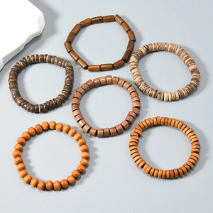 Detailed set of six handmade wooden bead bracelets featuring natural textures and brown tones